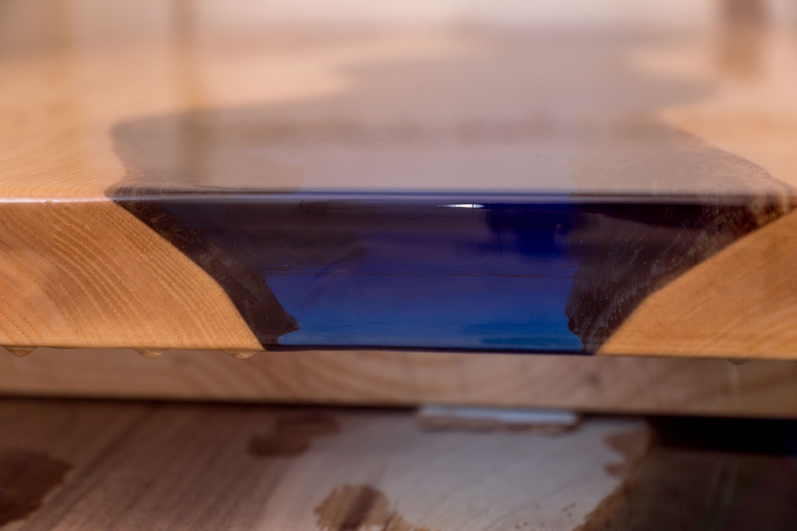 Epoxy resin in cracked walnut massif. Artistic processing of wood. furniture loft. modern furnishings.table-tops.